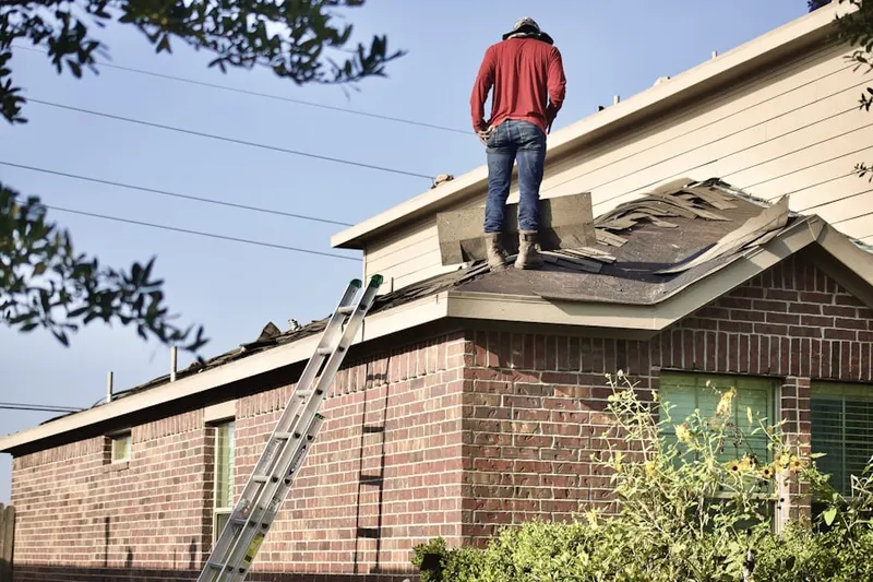 Professional roofer working on a residential roof in Lovely Street